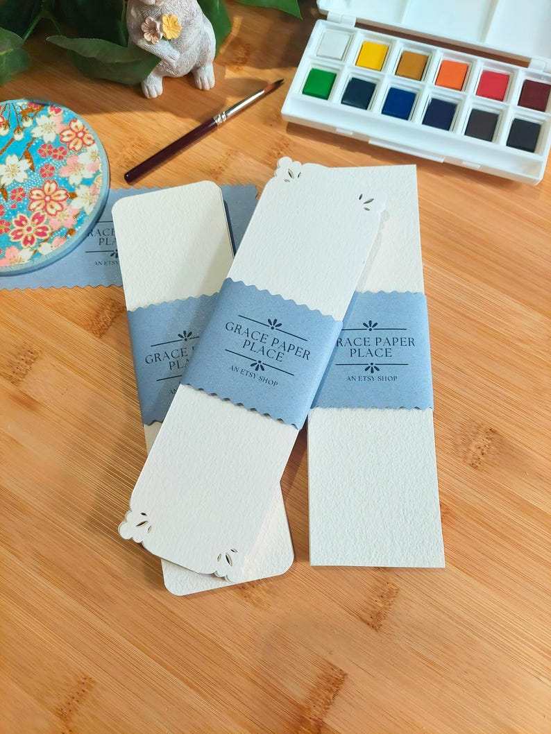 May include: Three white bookmark cards with scalloped edges and a blue banner that reads "Grace Paper Place, An Etsy Shop".