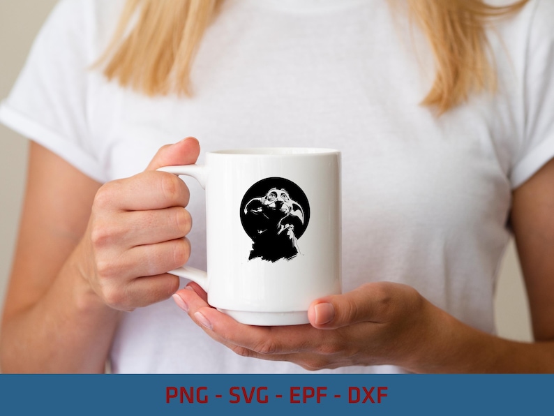May include: A white ceramic mug featuring a black and white graphic illustration of a small creature with large ears and wrinkled skin centered within a solid black circle. The mug has a smooth finish and a curved handle on the left side.