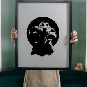 May include: A black and white digital illustration of a small creature with large ears and wide eyes, centered within a black circle inside a rectangular black frame. The text SVG - PNG - EPS - DXF is printed in white at the bottom of the image.