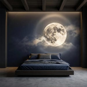 May include: A modern bedroom with a large, illuminated full moon design on the wall above a bed. The bed has a dark blue comforter and pillows. The room has a dark, moody aesthetic with a concrete floor.