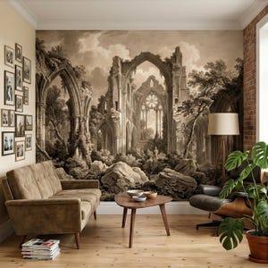 May include: A sepia-toned mural of a gothic cathedral ruin with arched windows and doorways, surrounded by trees and rocks. The room features a brown sofa, a wooden coffee table, and a floor lamp with a beige shade. A potted plant and framed photos complete the scene.