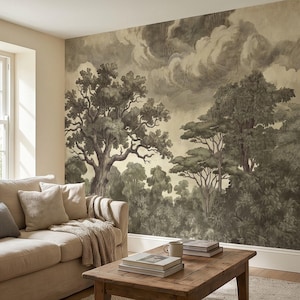 May include: A sepia-toned mural depicting a forest scene with large trees and a cloudy sky. The artwork is on a wall behind a beige sofa and a wooden coffee table. The room has a neutral color palette.