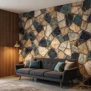 May include: A contemporary living room with a grey sofa and teal and brown cushions. The feature wall is a stone mosaic in beige, blue, and black, highlighted with gold. Two gold floor lamps are positioned on either side of the sofa.