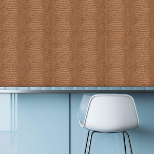 May include: A close-up of a brown textured wall with a reptile skin pattern. The wall is above a light blue surface with a white chair with black legs. The chair is in the lower right corner of the image.