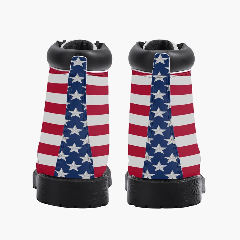 May include: Pair of ankle boots featuring the American flag design. The boots have a black collar, sole, and heel. The sides of the boots display red and white stripes, with a blue panel featuring white stars.