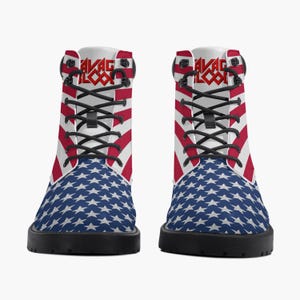 May include: Pair of combat boots featuring a patriotic design. The boots display a blue star pattern on the lower portion and red and white stripes on the upper part. The boots have black laces and soles, with the text "SAVAGE BLOOD" in red.
