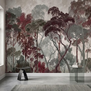 May include: A wall mural featuring a dense forest scene with tall trees in shades of deep burgundy, muted green, and grey. The artwork displays a layered canopy effect against a pale, cloudy background, creating a sense of depth and texture.