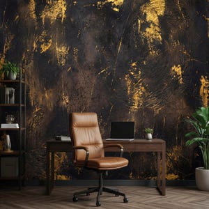 May include: A home office setup featuring a brown leather office chair, a wooden desk with a laptop, and a dark textured wall with gold accents. A bookshelf and potted plants add to the decor.