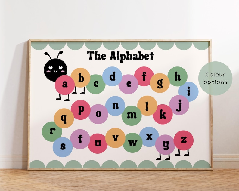 May include: A framed educational poster with a colourful alphabet design. The letters are arranged in a caterpillar shape, each letter inside a different coloured circle. The poster has a light green scalloped border and the words "The Alphabet" at the top.