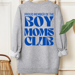 May include: Gray sweatshirt with blue text that reads "Proud Member of the Boy Moms Club".