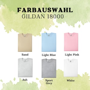 May include: A selection of Gildan 18000 t-shirts in various colors, including sand, light blue, light pink, ash, sport grey, and white.