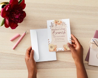 May include: A white envelope with a floral Mother's Day brunch invitation card. The card has a brown background with a floral design and the text "Mother's Day Brunch" in brown lettering. The text "May 12 at 2:00PM" is printed in black lettering. The card also includes the address "123 anywhere st, any city, St 12345".