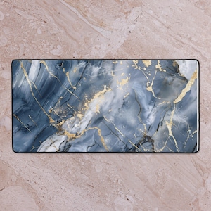 May include: Rectangular desk mat with a marble design. The mat features a dark blue and white marbled pattern with gold veining. The mat has a black border.
