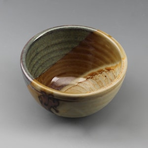 May include: A white ceramic mug with a wraparound design featuring a vibrant, colorful illustration of various mushrooms. The mug has a black handle and a glossy finish. The text "Shroom Queens" is printed on the mug.