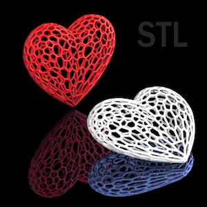 Puede incluir: Dos corazones impresos en 3D, uno rojo y otro blanco, con un diseño de celosía. Los corazones están sobre un fondo negro con la palabra "STL" en texto blanco.