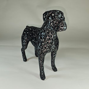 May include: A black wireframe sculpture of a dog, with a detailed, intricate design. The sculpture is made of thin metal wires that are woven together to create a three-dimensional form.