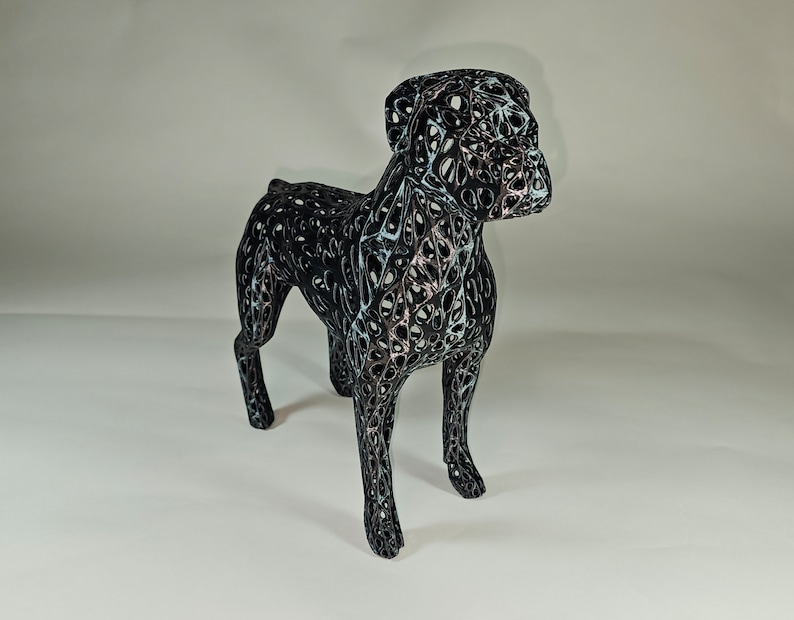 May include: A black wireframe sculpture of a dog, with a detailed, intricate design. The sculpture is made of thin metal wires that are woven together to create a three-dimensional form.