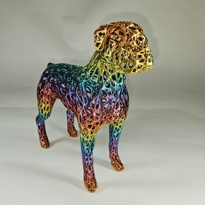 May include: A rainbow-colored, 3D printed dog sculpture. The dog is standing on all four legs and has a detailed, intricate design.