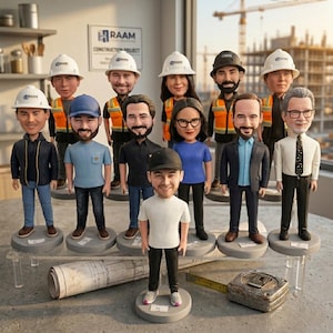 May include: A group of bobblehead figures of construction workers, each wearing a hard hat and various outfits. The figures stand on individual gray bases, with a blueprint and measuring tape in the foreground. The background shows a construction site.