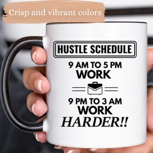 May include: White ceramic mug with a black handle and rim. The mug features the text "HUSTLE SCHEDULE" above the text "9 AM TO 5 PM WORK" and "9 PM TO 3 AM WORK HARDER!!". A briefcase graphic is also included.