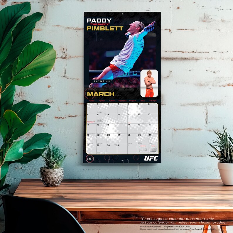 May include: A 2027 UFC wall calendar featuring a photograph of Paddy Pimblett in a fighting stance for the month of March. The calendar includes a grid for the month, the text PADDY THE BADDY PIMBLETT, and a smaller inset photo of the athlete.