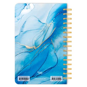 May include: A blue and gold spiral bound notebook with a marbleized design. The cover features the text "brown trout" and "CRACKLED BLUSH". The UPC code is 840431190024 and the ISBN is 978-3-507-00024-0.