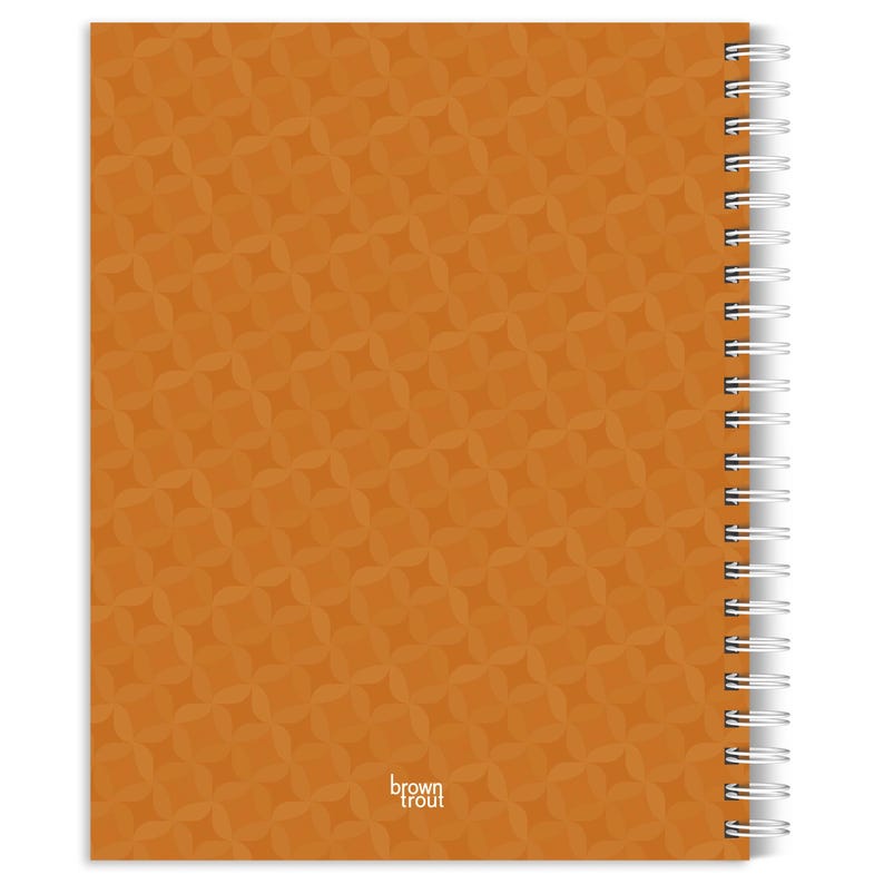 May include: A spiral-bound notebook with a solid orange cover featuring a repeating geometric pattern of interlocking petal shapes. The text brown trout is printed in small white letters near the bottom center of the front cover.