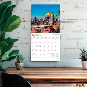 K&ouml;nnte beinhalten: Ein Wandkalender f&uuml;r den Monat M&auml;rz mit einer Fotografie einer Kathedrale mit einer gro&szlig;en gelben Kuppel und mehreren T&uuml;rmen vor einem klaren blauen Himmel. Das Kalenderraster zeigt die Tage des Monats mit dem Text MARZO oben.