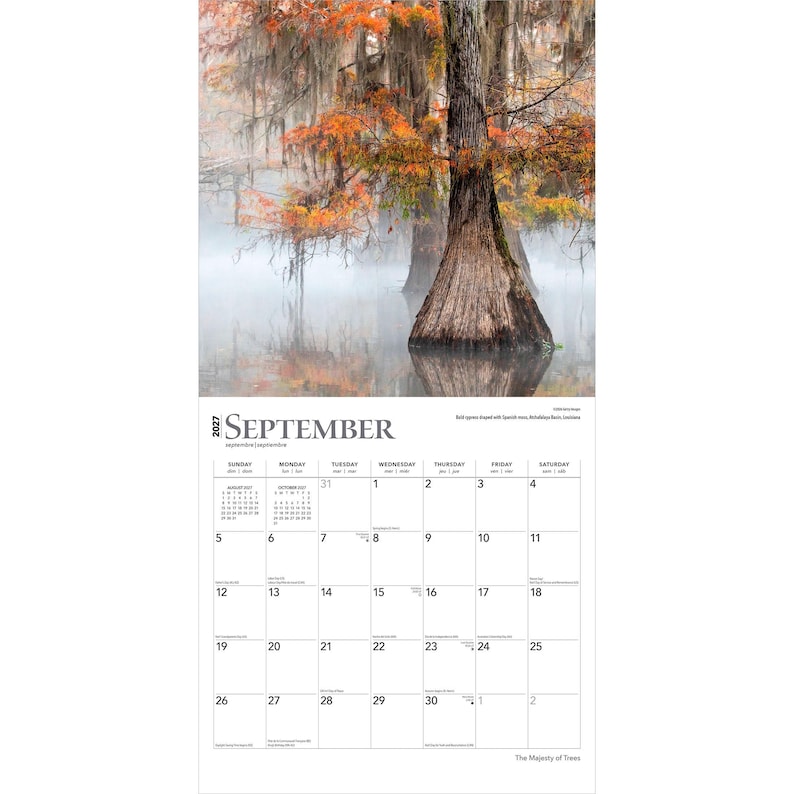May include: A 2027 wall calendar page for September featuring a photograph of cypress trees with orange autumn foliage and Spanish moss in a misty swamp. The grid displays the days of the month with Sunday through Saturday headers in black text.