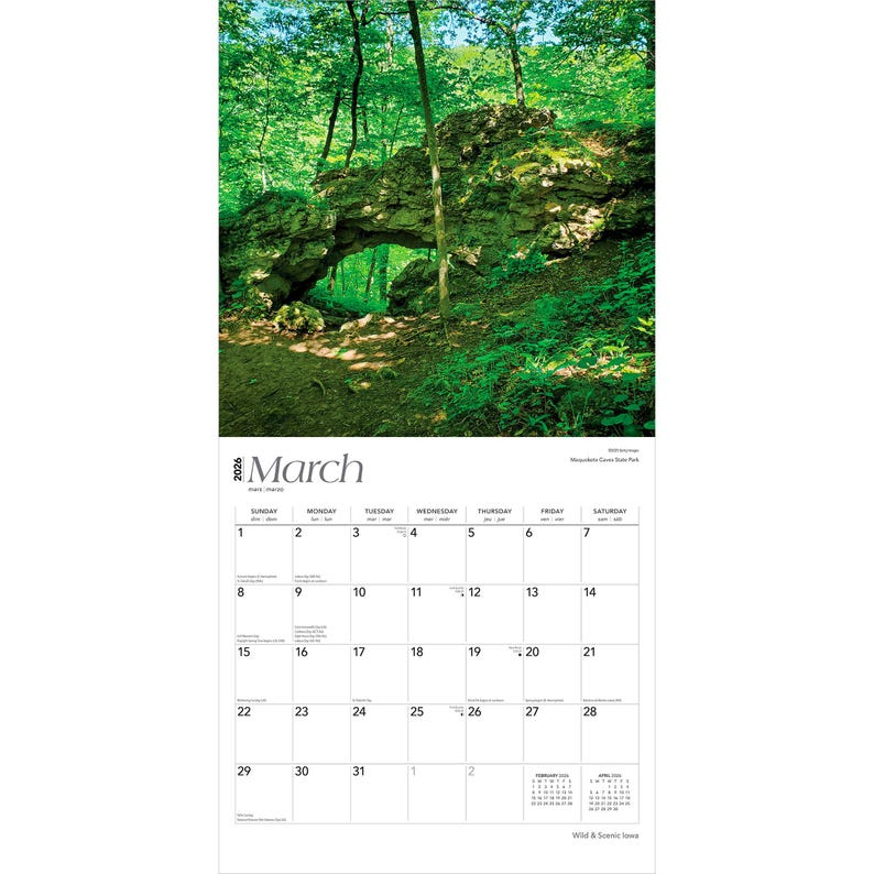 May include: A calendar page for March 2026 showing a natural rock archway in a green forest. The calendar grid is white with black numbers and dates. The word "March" is at the top. The image is of a scenic landscape.
