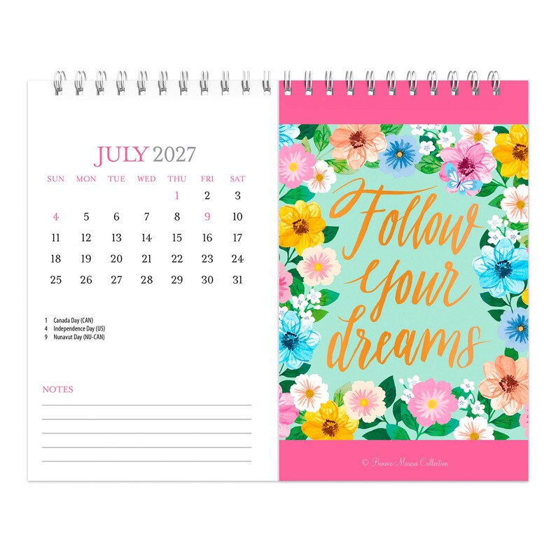 May include: A spiral-bound desk calendar for July 2027. The left page shows the calendar grid with dates and holidays. The right page features a light green background with a floral border and the gold cursive text Follow your dreams.