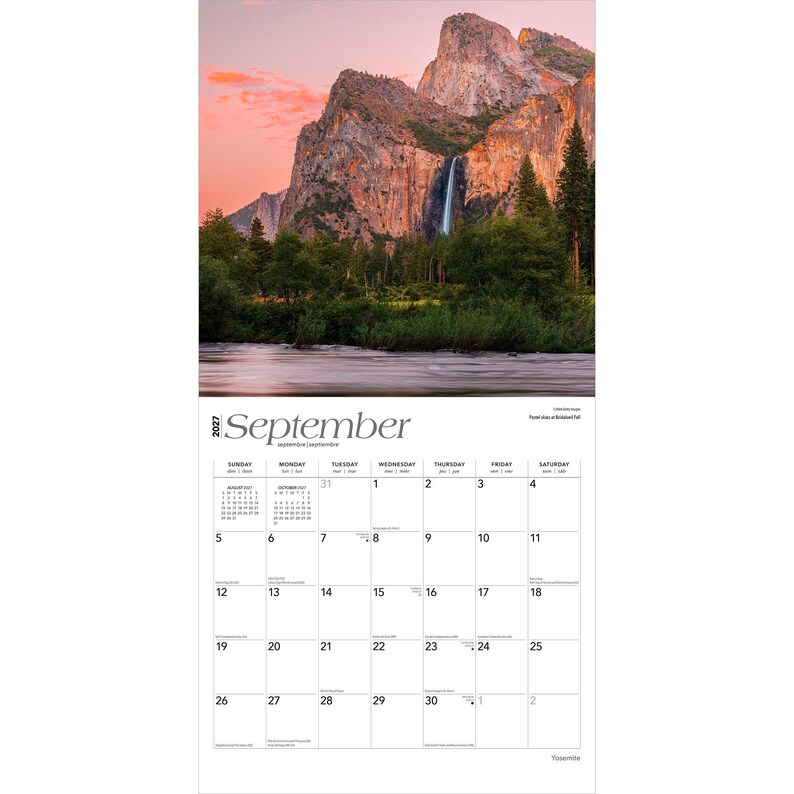 May include: A 2027 wall calendar page for September featuring a photograph of a waterfall cascading down a rocky mountain cliff at sunset. The calendar grid displays the days of the month with black text on a white background, including small monthly calendars for August and October.
