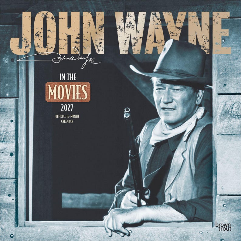 May include: A 2027 calendar featuring John Wayne in the movies. The image shows a black and white photo of John Wayne in a cowboy hat, holding a rifle. The calendar has the text "John Wayne" at the top and "In The Movies" in the center.