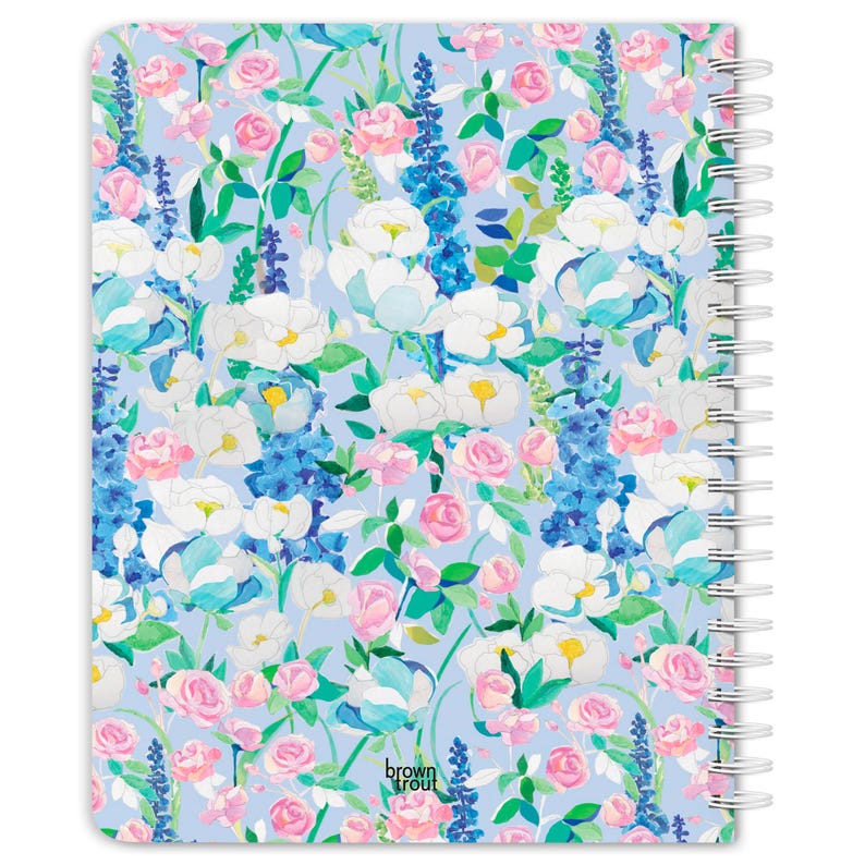 May include: A spiral-bound notebook with a floral pattern. The design features white, pink, and blue flowers on a light blue background. The words "brown trout" are printed in the lower right corner.