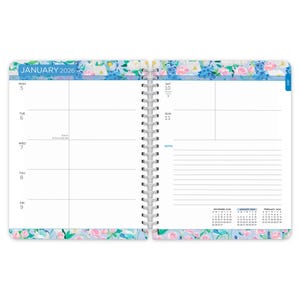 May include: Open spiral-bound planner for January 2026, featuring a floral border with blue, pink, and white flowers. The left page displays the week's days, while the right page has space for notes. The month and year are printed at the top.