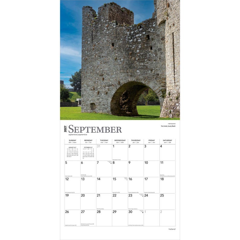 May include: A 2027 wall calendar for the month of September featuring a photograph of a weathered stone castle ruin with a large arched entryway set against a bright blue sky and green grass. The calendar grid displays dates, days of the week, and small monthly views for August and October 2027.