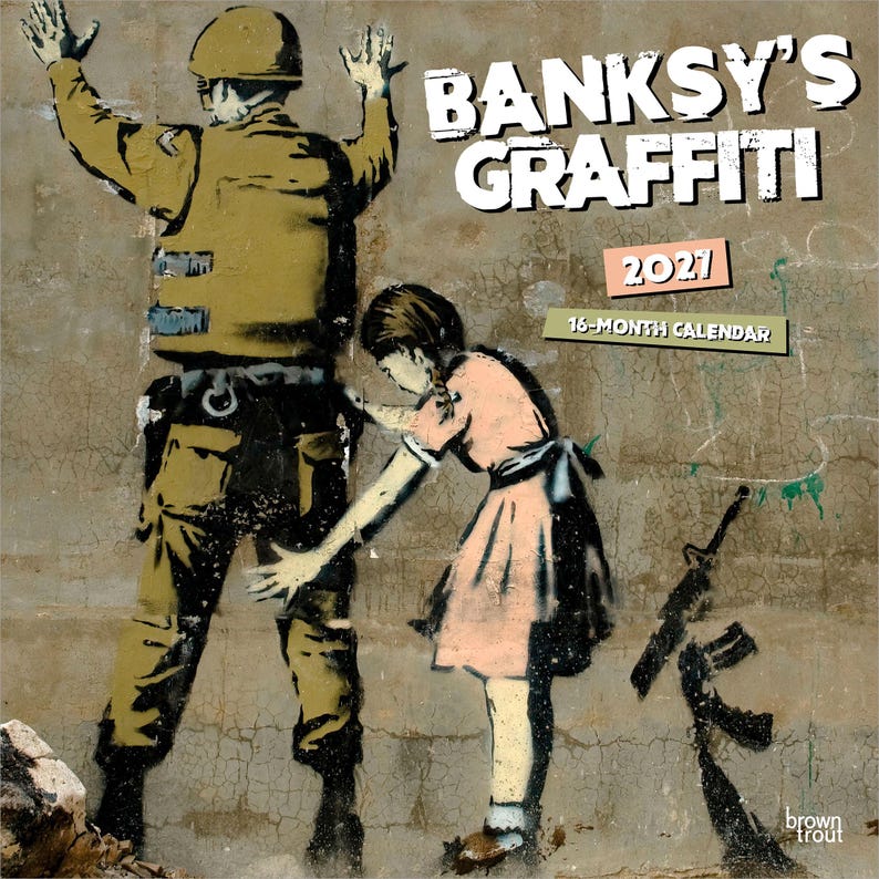 May include: A Banksy's Graffiti 2021 16-month calendar. The image features a stencil of a soldier with his hands up and a girl reaching towards him. An assault rifle is on the ground. The calendar has a brown trout logo.