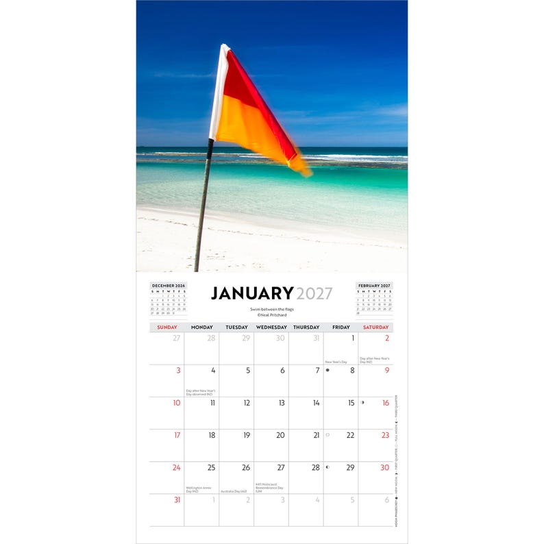 May include: A wall calendar for January 2027 featuring a photograph of a red and yellow beach flag on a pole against a blue sky and turquoise ocean. The calendar grid displays the month, days of the week, and dates with small text annotations.