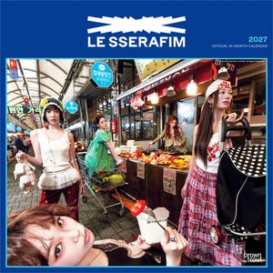 May include: A 2027 LE SSERAFIM official 16-month calendar featuring a group of people in a market setting. One person holds a raw chicken, another pushes a shopping cart, and a third holds a fork with a tomato over a white food container.