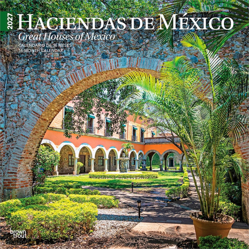 May include: A 2027 16-month calendar titled Haciendas de M&eacute;xico Great Houses of Mexico featuring a photograph of a stone archway framing a peach-colored building with arched corridors, a central fountain, and green landscaping in a courtyard.
