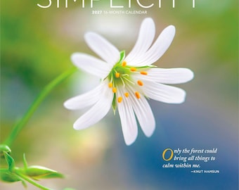May include: A 2027 16-month calendar titled SIMPLICITY featuring a white flower with yellow centers against a blurred green and blue background. The text reads Only the forest could bring all things to calm within me and Brush Dance.