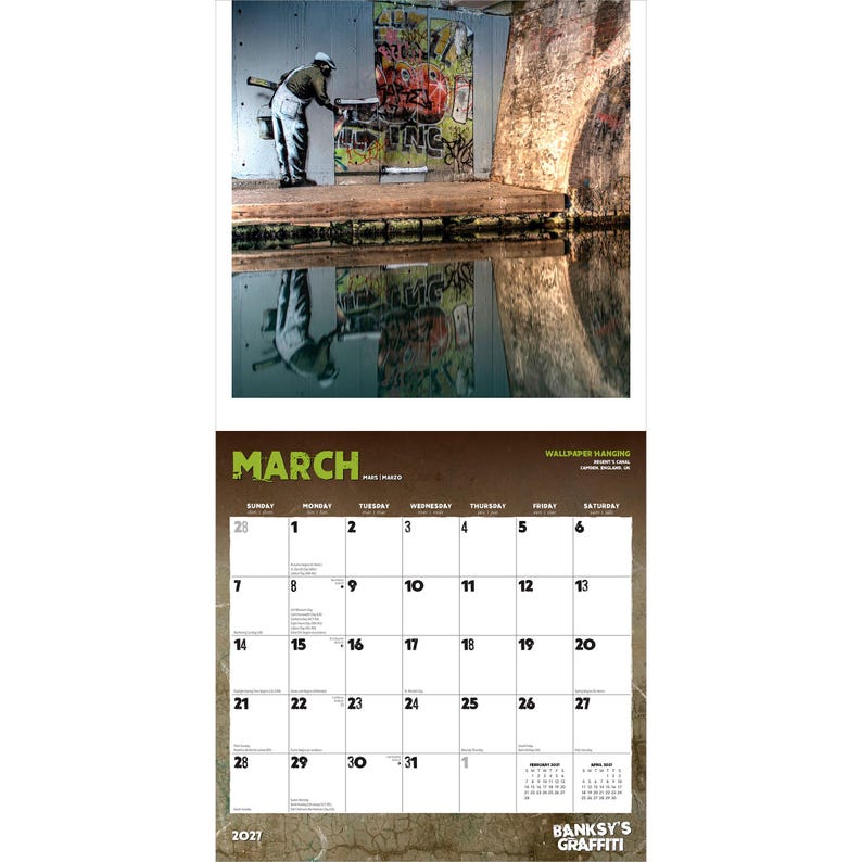 May include: A Banksy's Graffiti calendar for March 2021, featuring a street art scene with a person applying graffiti to a wall. The image is reflected in the water below. The calendar includes dates from March 28 to April 3.