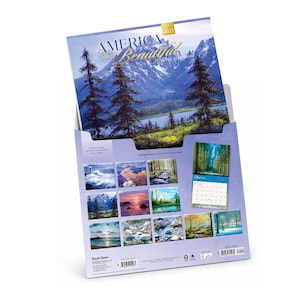 May include: A 2027 America the Beautiful wall calendar by Peter Ellenshaw featuring a landscape of mountains, pine trees, and a lake. The back cover displays twelve smaller monthly images of nature scenes, including forests, oceans, and snowy landscapes.