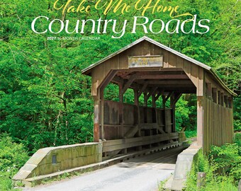 May include: A 2027 16-month calendar titled West Virginia Take Me Home Country Roads featuring a photograph of a brown wooden covered bridge surrounded by lush green trees. The text on the calendar cover includes the title and the year.