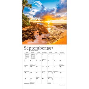 May include: A wall calendar for September 2027 featuring a photograph of a tropical beach at sunset with golden light, dark volcanic rocks, and palm trees. The calendar grid displays the days of the month with small text for holidays and dates.