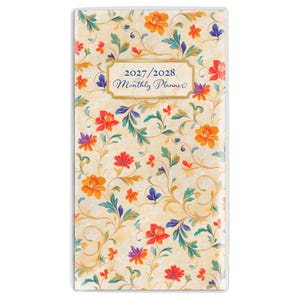 May include: A rectangular monthly planner with a cream-colored background featuring a repeating floral pattern in shades of orange, red, purple, and teal. A central gold-bordered label displays the text 2027/2028 Monthly Planner in blue.
