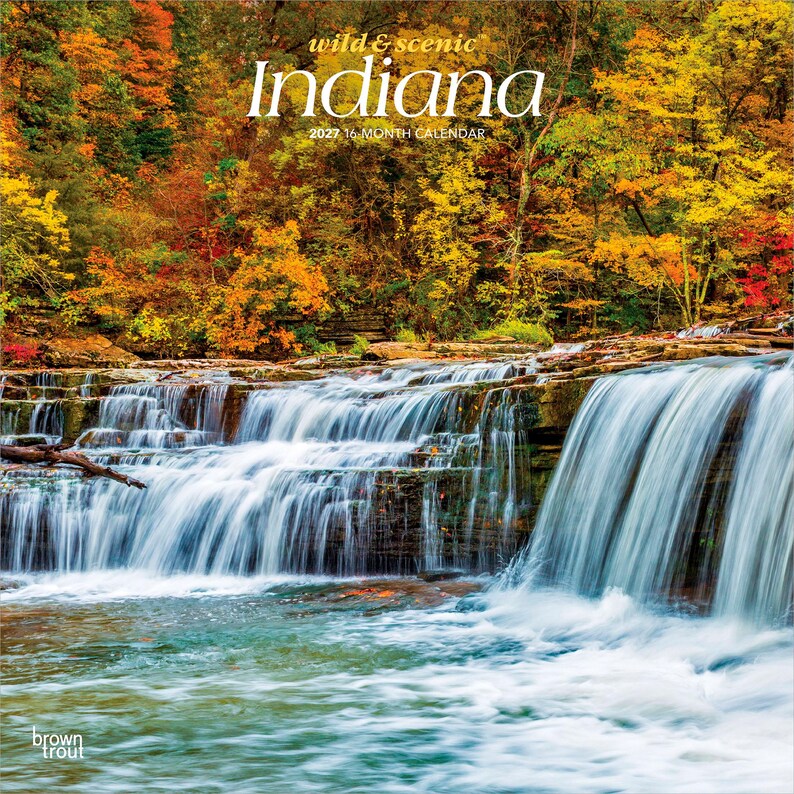 May include: A 2027 16-month calendar titled Wild & Scenic Indiana featuring a photograph of a cascading waterfall surrounded by autumn foliage in shades of yellow, orange, and red. The BrownTrout logo is visible in the bottom left corner.