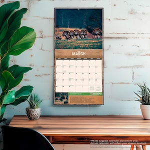 May include: A wall calendar featuring a wildlife scene with turkeys. The top portion displays a photograph of turkeys in a field, with the month of "March" printed in a brown banner. The calendar grid is below, with a "Gamekeeper" logo.