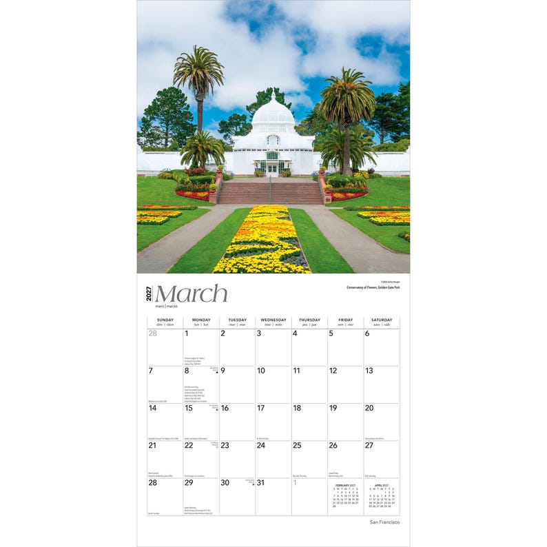 May include: A 2027 wall calendar for the month of March featuring a photograph of the white Conservatory of Flowers in San Francisco. The image shows a domed building, palm trees, and a vibrant yellow flower bed leading to a staircase.