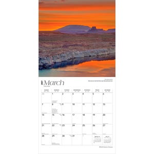 May include: A 2027 wall calendar for the month of March featuring a photograph of a sunset over Lake Powell in Glen Canyon National Recreation Area. The calendar grid displays dates from the 1st to the 31st with small February and April calendars.